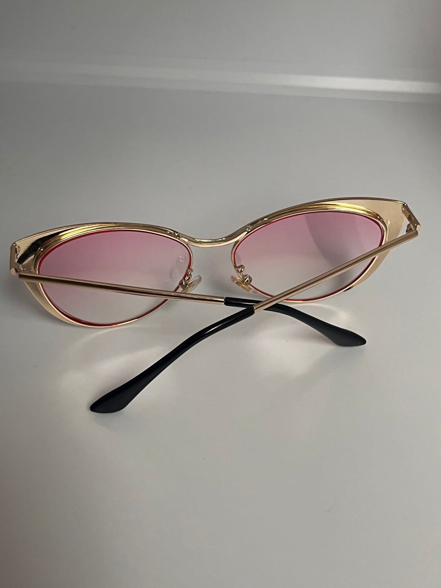 Solbriller  Cat Eye gullfarget med rosa gjennomsiktig glass.
